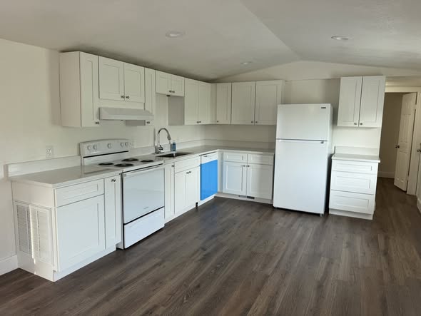 Remodeled kitchen at 112 Laureti Ln, Hidden Lake — white cabinets, new appliances, wood-look floors